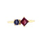 A two stone cluster ring with one blue round stone and a square princess cut deep pink stone on a thin gold band. 