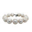 Product picture featuring a large fresh water pearl bracelet with silver taggle clasp. This bracelet is hand knotted with white silk in between each pearl. 