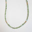 A square faceted green tourmaline beaded necklace with gold beaded accents and lobster clasp. 