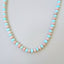 Product picture of a pink and blue alternate opal beaded necklace. The necklace is hand knotted with round wheel clasp. 