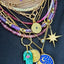 Picture of jewelry styling with roman gold coin and other pendant and necklaces. 