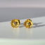 A pair of solid gold daisy earring with dainty pedals and a diamond center. 