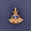 Showing a pendant that features an alien in a gold space ship. With the rainbow gemstones as the lights on the UFO. The alien is also iridescent. 