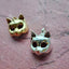 A product picture of a solid gold cat mast pendant. This charm is a mask of a cat made in 3d with round cute cat face and pointy ears. 